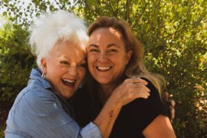 two women hugging each other in the care home gardens in Sussex
