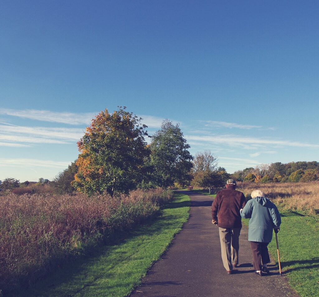 resident and couple walking outside