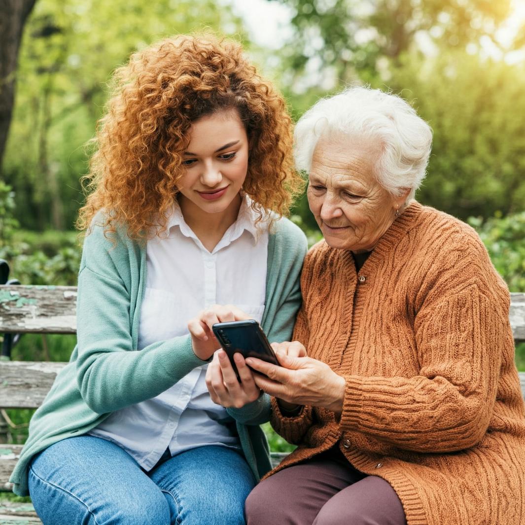 A young person showing an older relative their mobile phone