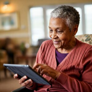 A resident using a tablet device to play memory games